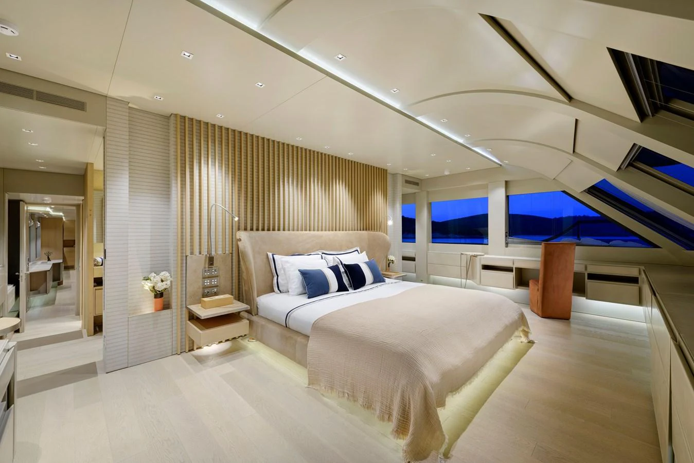 The master stateroom features a luxurious bed, modern furnishings, and expansive windows offering stunning views. aboard K Yacht for Sale