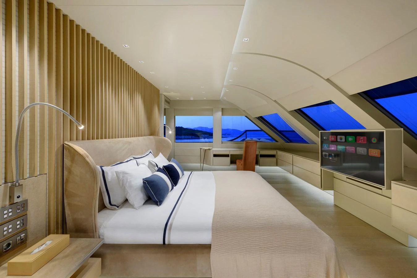The master stateroom features a luxurious bed, modern decor, and expansive windows offering stunning views. aboard K Yacht for Sale