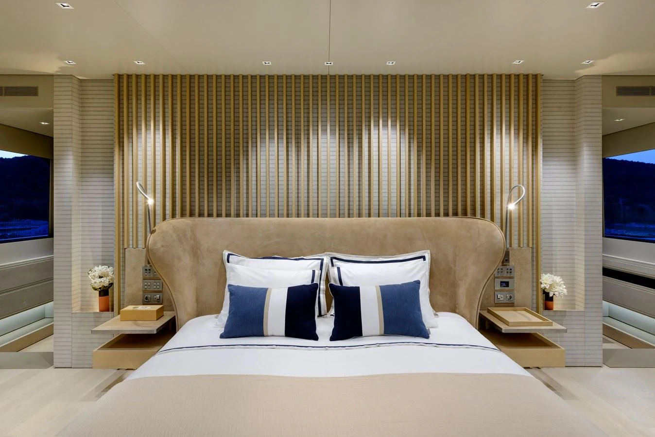 The master stateroom features a luxurious bed with elegant decor and modern lighting. aboard K Yacht for Sale