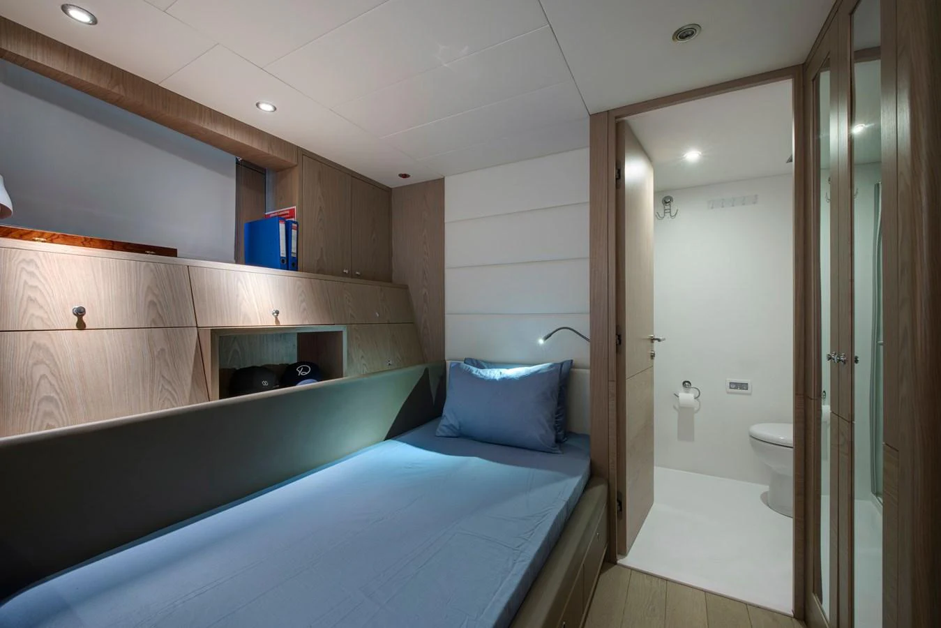 A cozy guest cabin with a single bed and an ensuite bathroom. aboard K Yacht for Sale