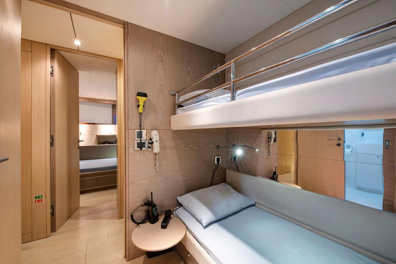 This cozy cabin features a bunk bed setup with modern amenities and a sleek design. aboard K Yacht for Sale
