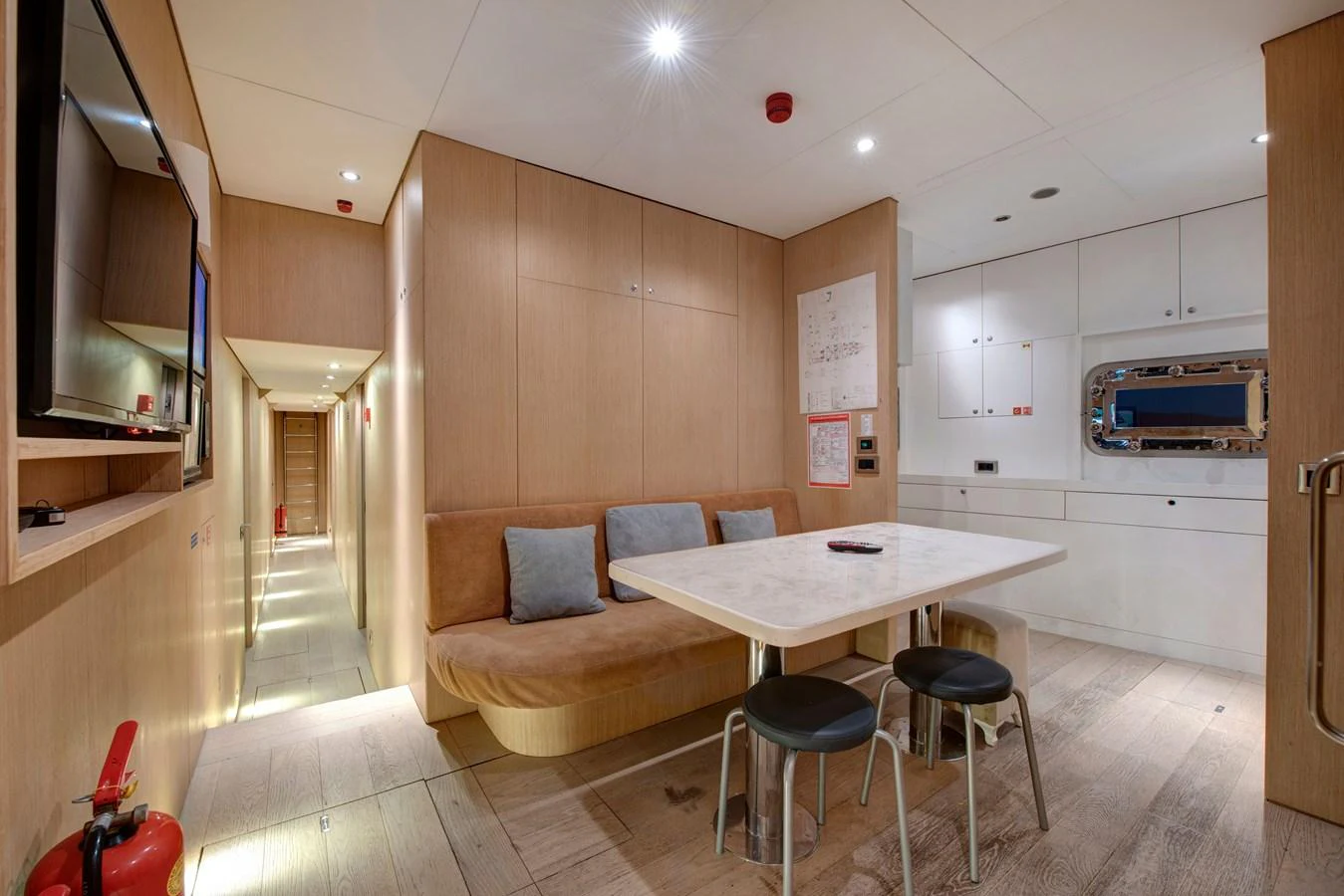 The galley features a cozy dining area with a built-in bench and modern amenities. aboard K Yacht for Sale