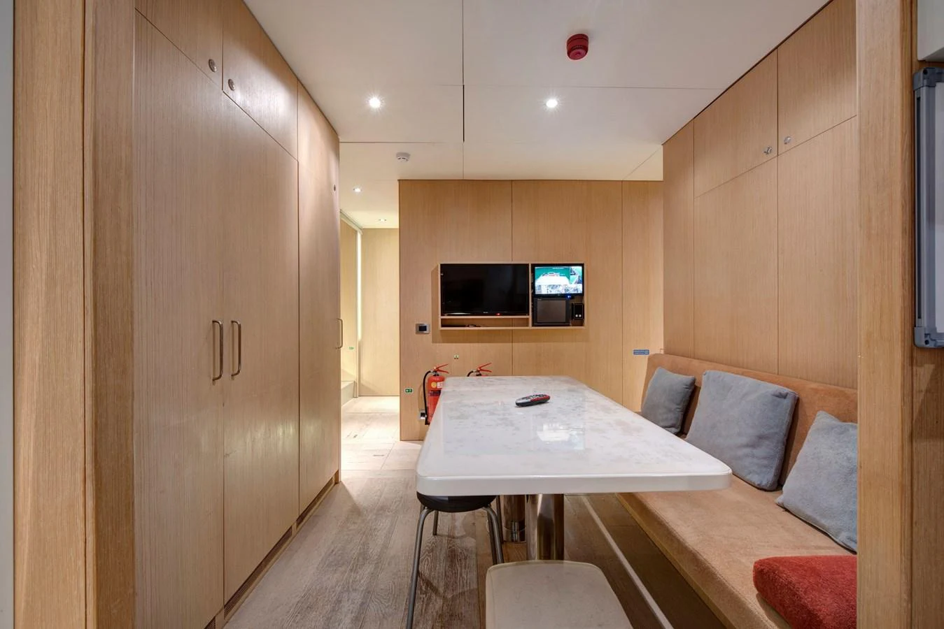 The yacht's dining area features a sleek table with comfortable seating and modern amenities. aboard K Yacht for Sale