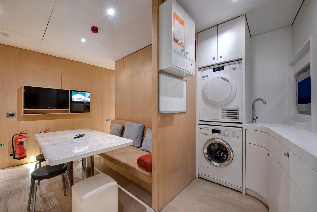 The crew area features a compact dining nook and laundry facilities, ensuring comfort and convenience for the staff. aboard K Yacht for Sale