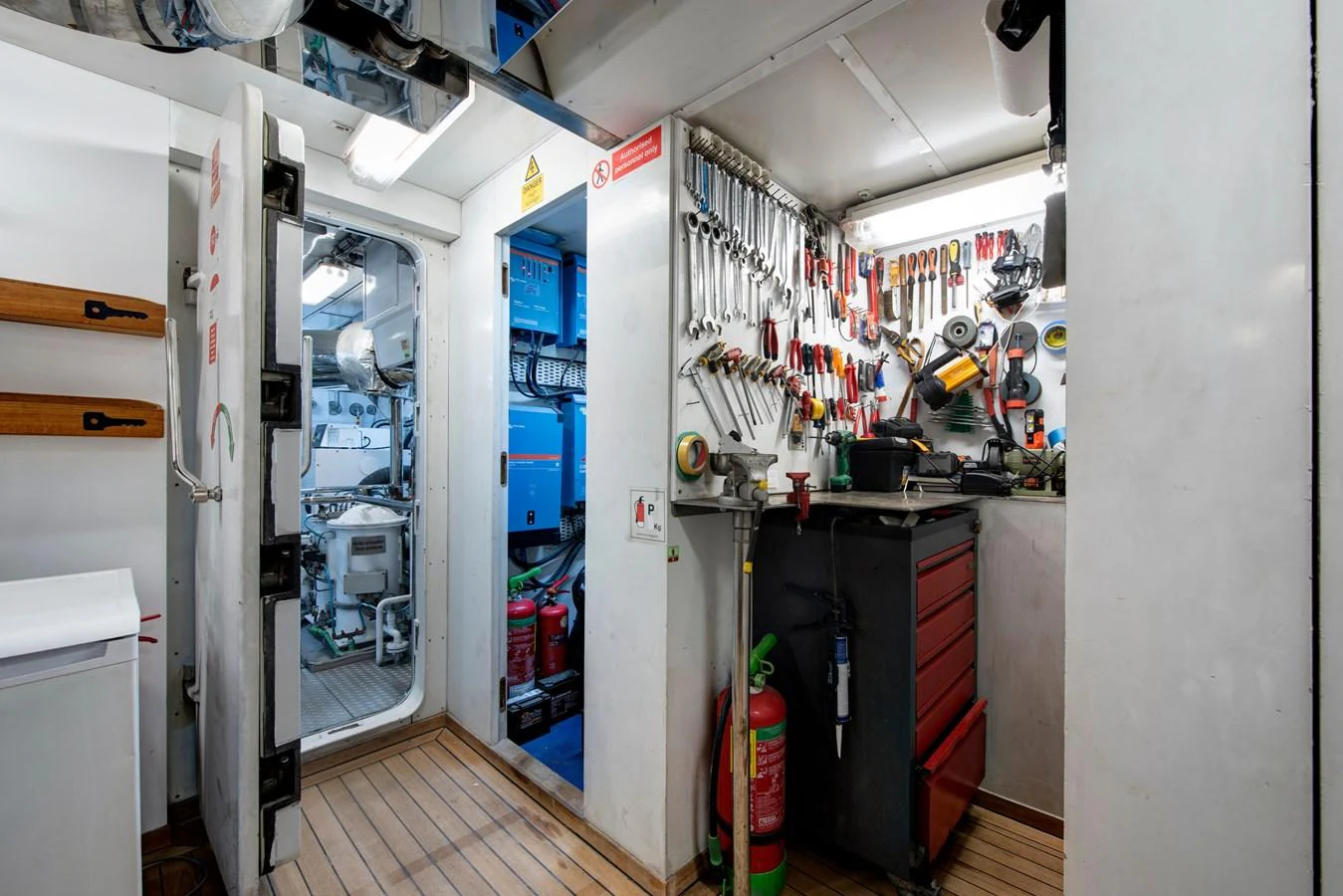 The yacht's engine room is well-organized, featuring an array of tools and equipment for maintenance. aboard K Yacht for Sale