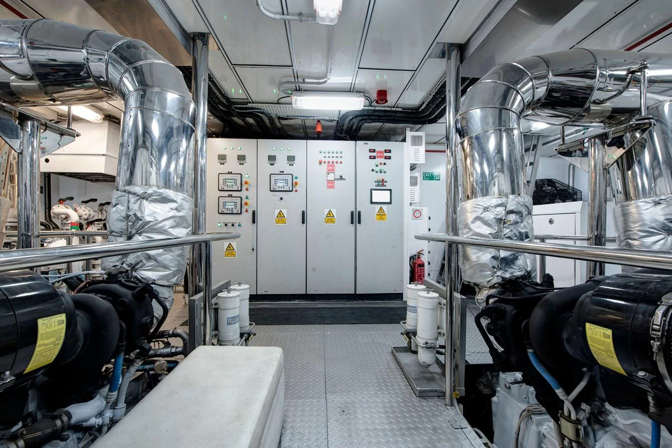The engine room showcases advanced machinery and control panels, emphasizing the yacht's engineering excellence. aboard K Yacht for Sale
