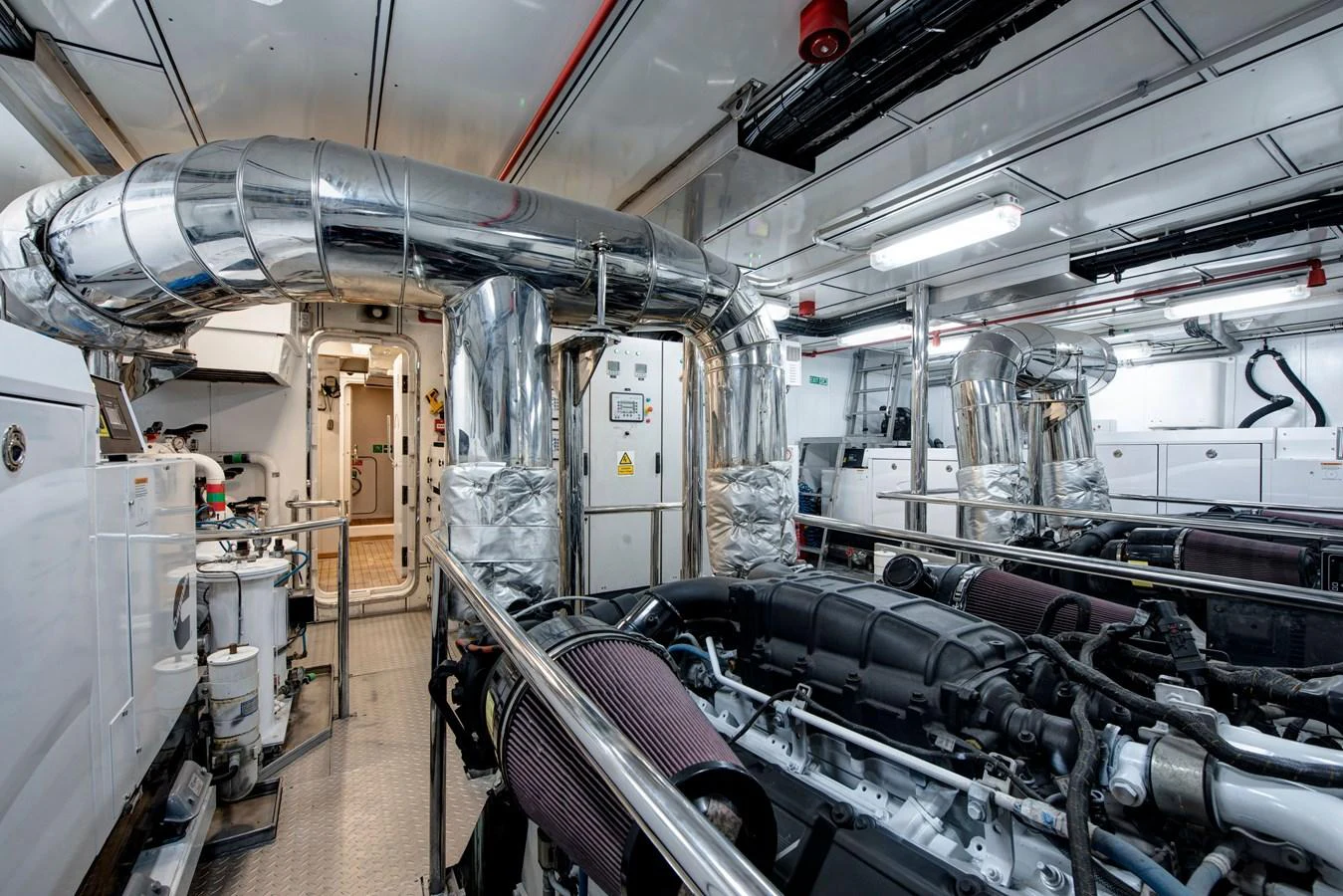 The engine room showcases advanced machinery and a clean, organized layout. aboard K Yacht for Sale