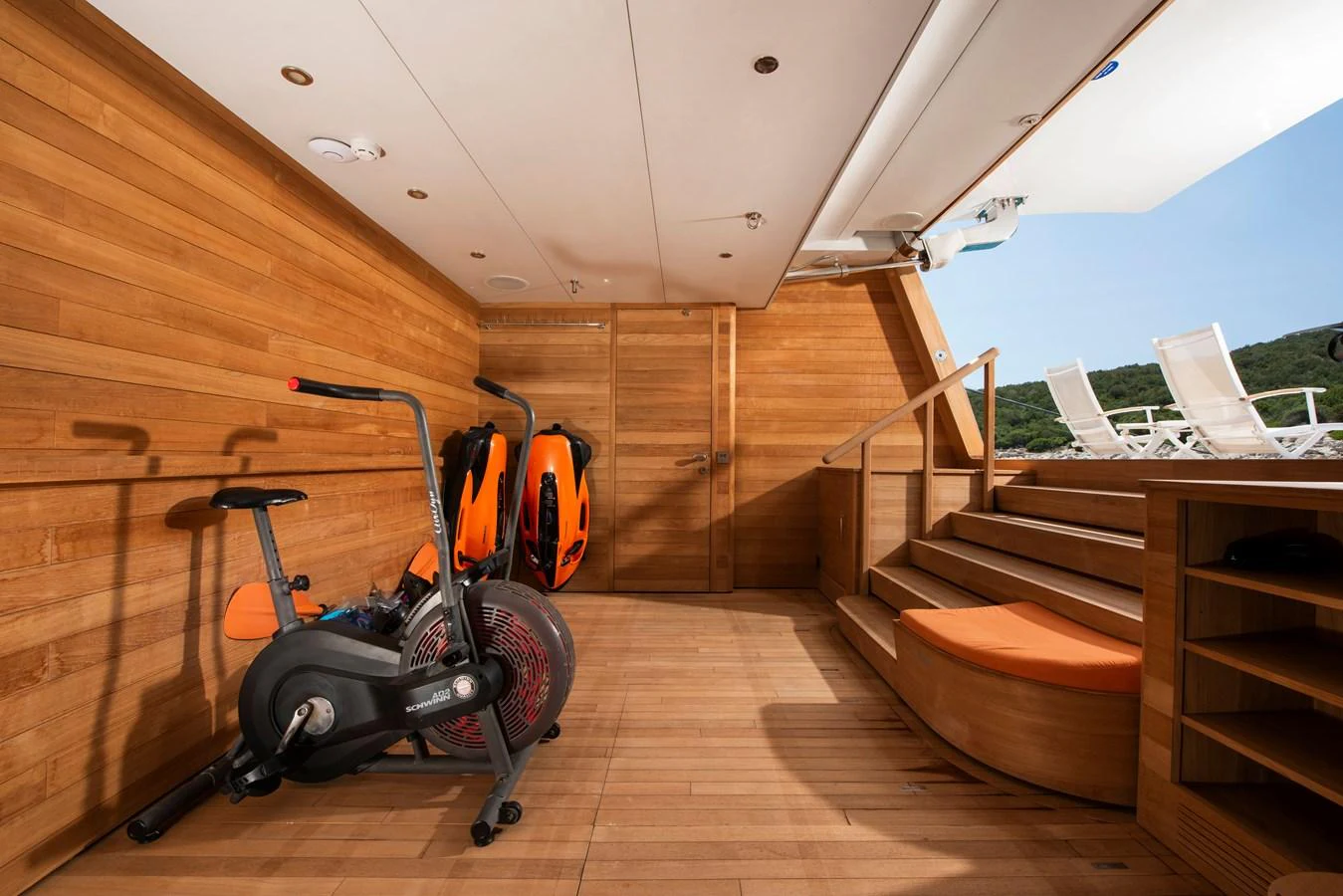The yacht features a well-equipped gym area with exercise bikes and a serene view. aboard K Yacht for Sale