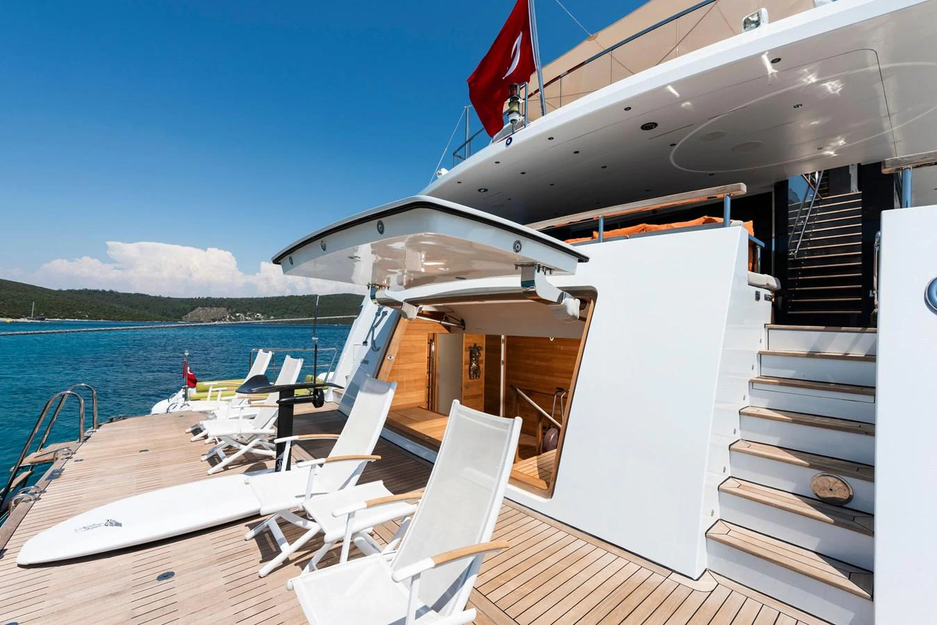 The yacht's aft deck features comfortable seating and easy access to the water. aboard K Yacht for Sale