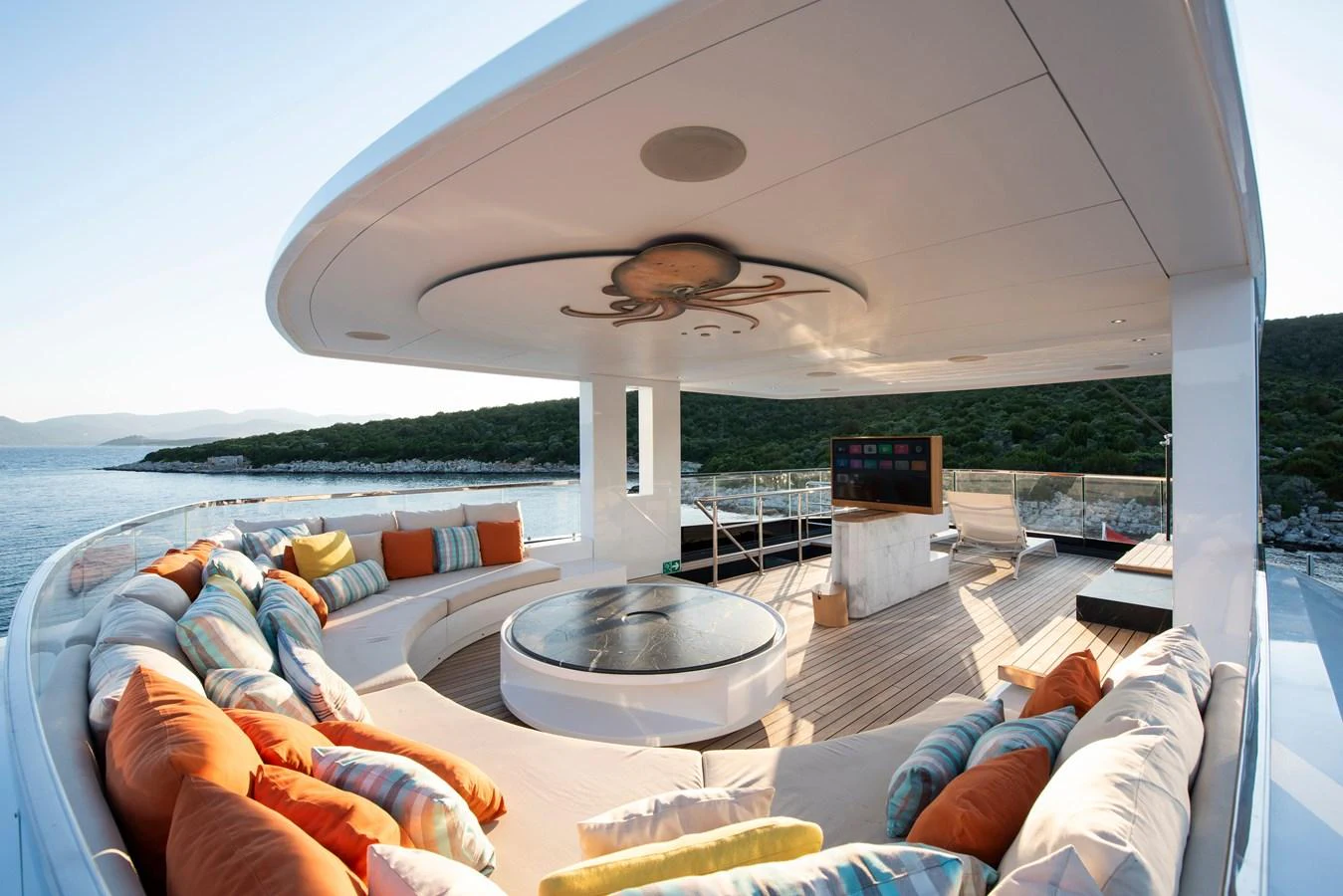 The sundeck features a spacious seating area with vibrant cushions and a central jacuzzi, perfect for relaxation. aboard K Yacht for Sale