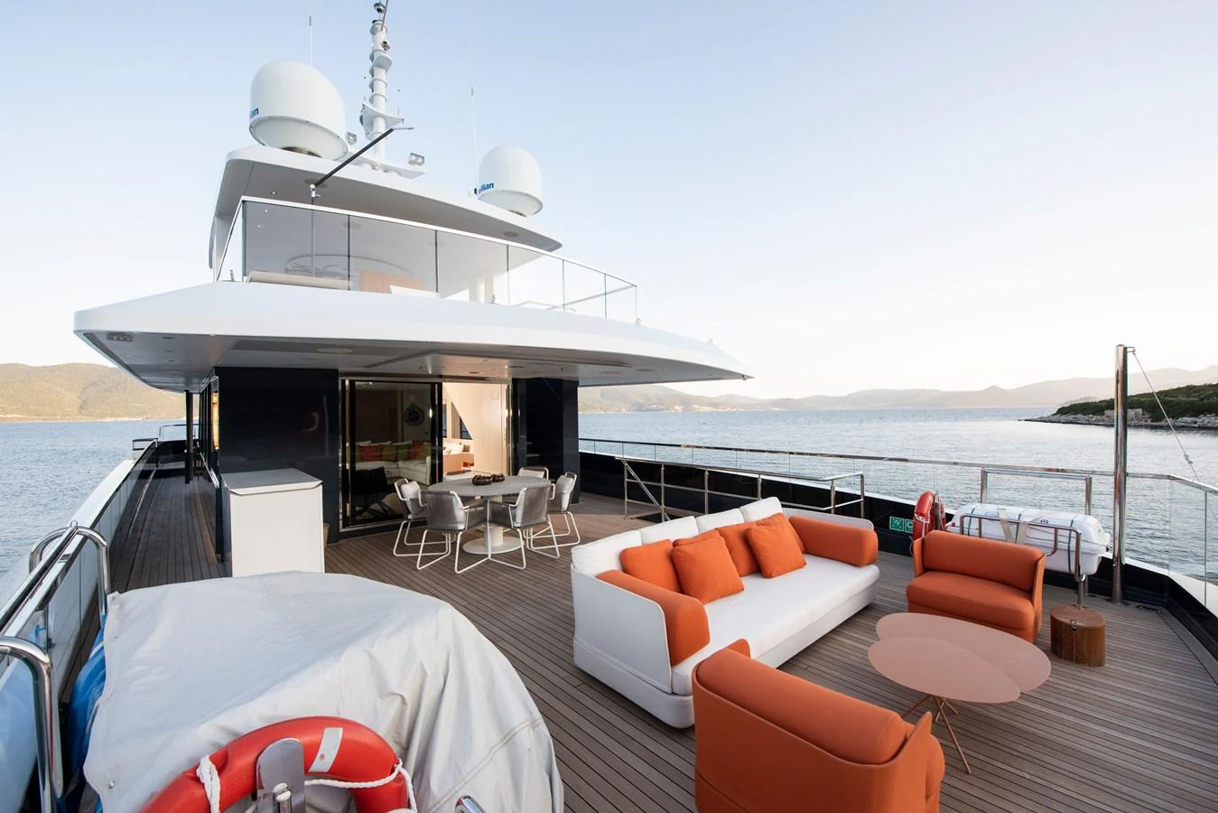 The aft deck features a spacious lounging area with modern furniture and a stunning view of the water. aboard K Yacht for Sale