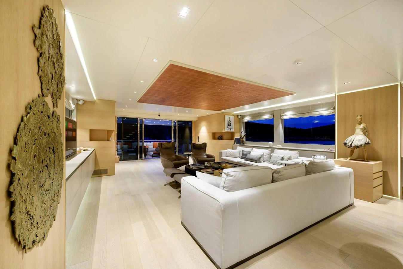 The salon features a spacious and elegantly designed seating area with modern decor and ample natural light. aboard K Yacht for Sale