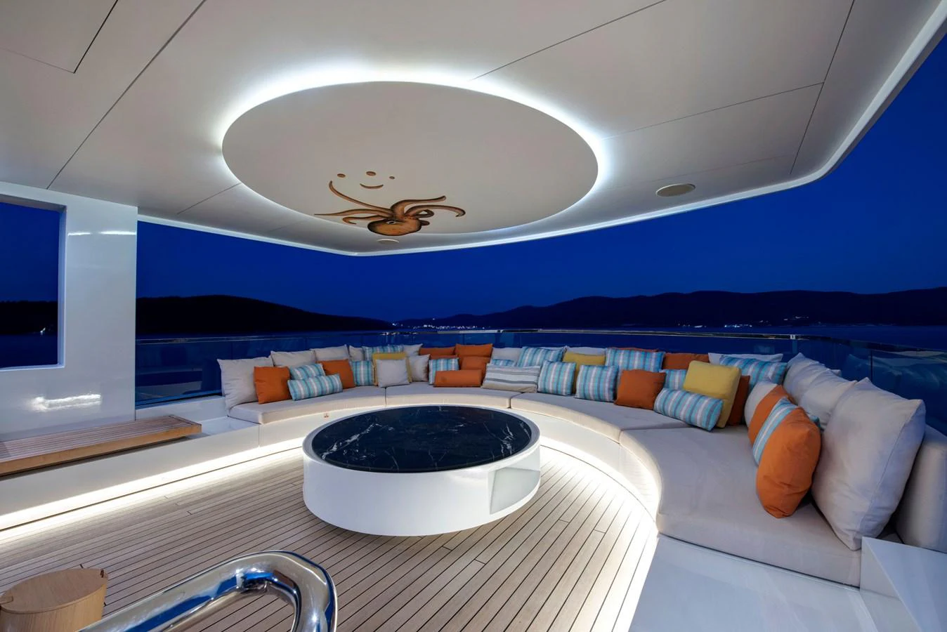 The sundeck features a stylish circular seating area with vibrant cushions and a modern ceiling design, perfect for evening relaxation. aboard K Yacht for Sale
