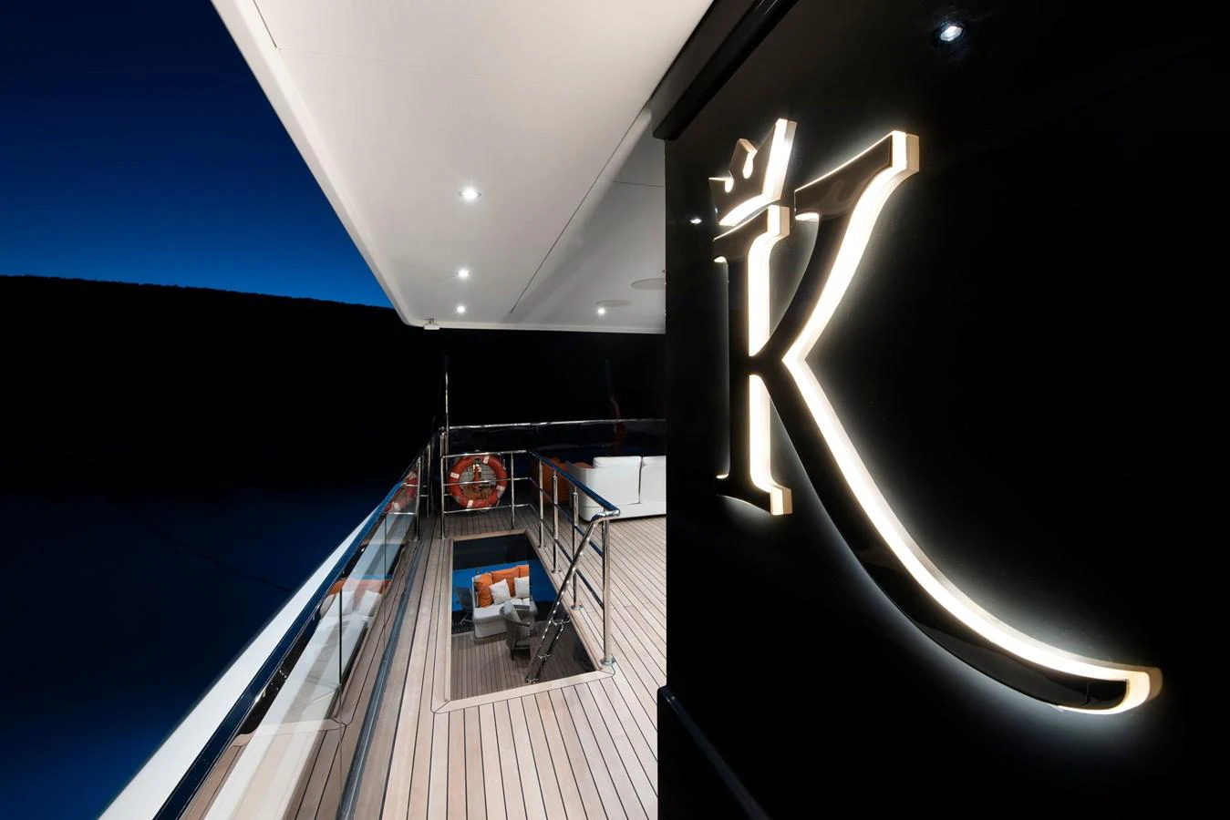 The aft deck of the yacht features elegant lighting and a stylish seating area, perfect for evening relaxation. aboard K Yacht for Sale
