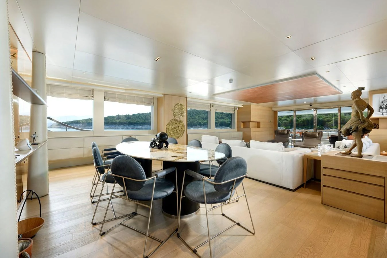 The spacious salon features modern furnishings with ample natural light and scenic views. aboard K Yacht for Sale