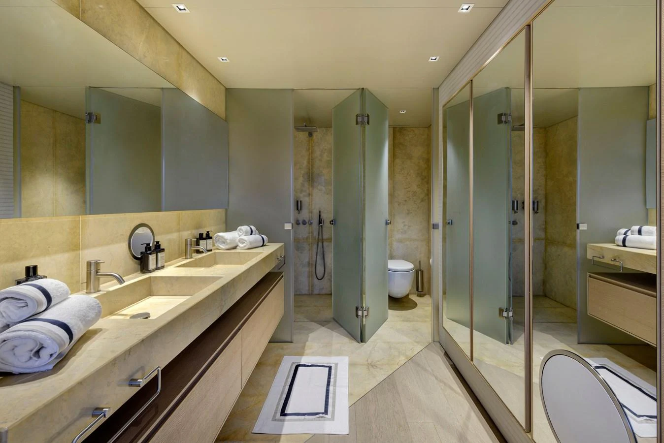 The yacht's bathroom features a luxurious design with double sinks, a spacious shower, and elegant finishes. aboard K Yacht for Sale