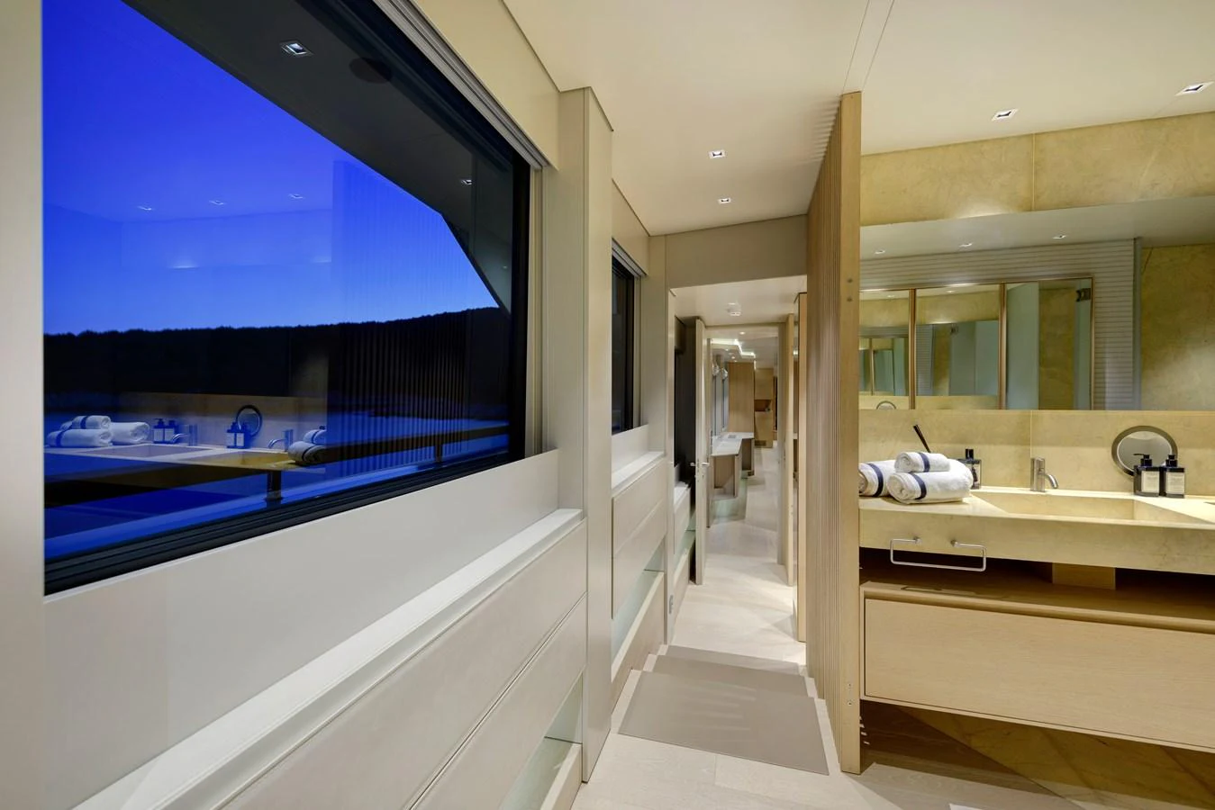 The yacht's interior features a sleek and modern bathroom with large windows offering a serene view. aboard K Yacht for Sale