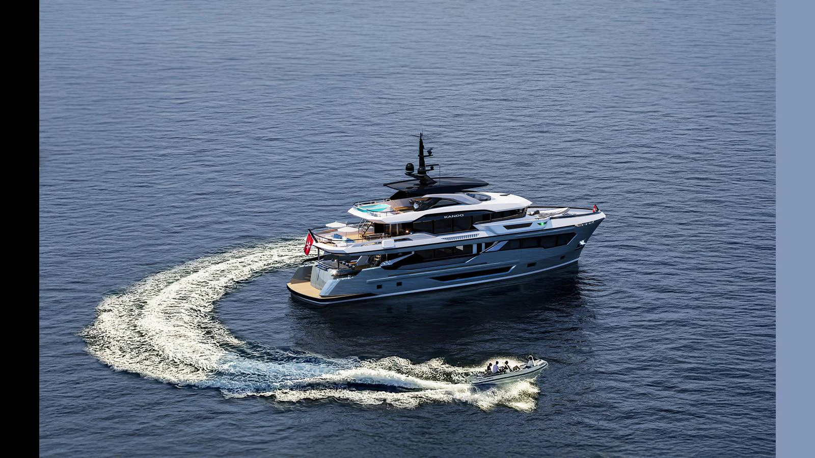 A luxurious yacht cruises through calm waters, accompanied by a smaller tender boat. aboard KANDO 120 Yacht for Sale