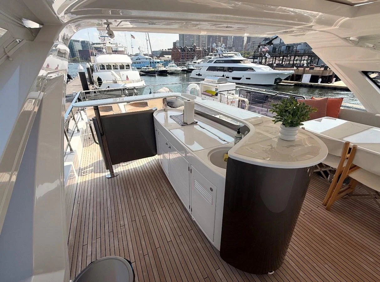 This yacht features a stylish outdoor bar area with a view of the marina. aboard 2022 AZIMUT GRANDE 25M Yacht for Sale