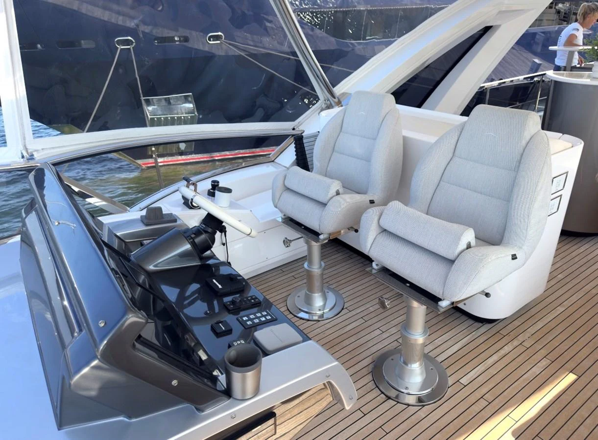 The yacht's helm features modern controls and comfortable seating, offering a commanding view for navigation. aboard 2022 AZIMUT GRANDE 25M Yacht for Sale