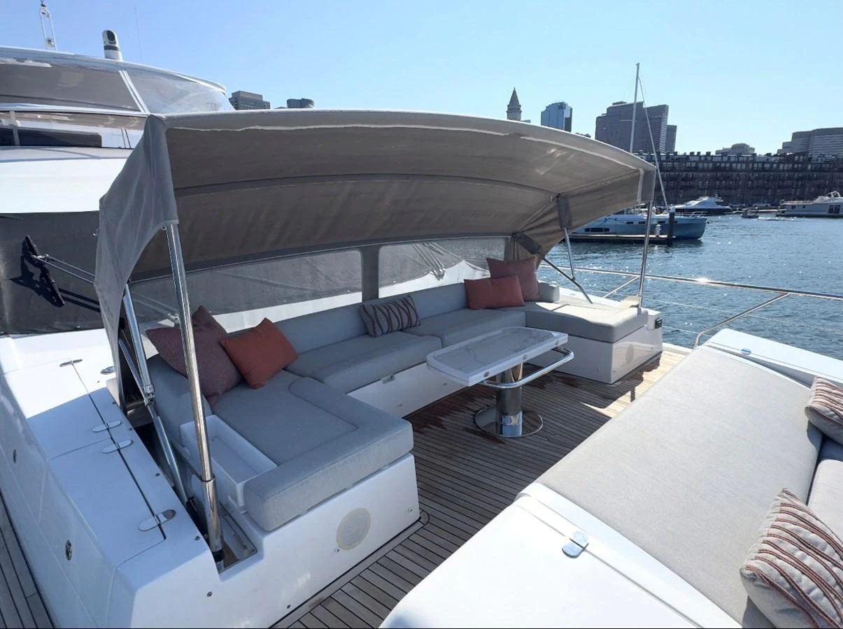The aft deck features a comfortable seating area with a retractable canopy, perfect for relaxation and socializing. aboard 2022 AZIMUT GRANDE 25M Yacht for Sale