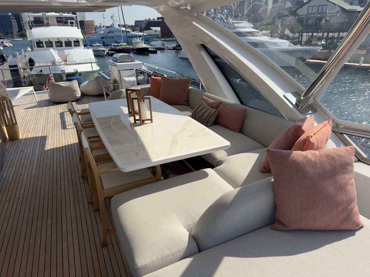 The aft deck features a stylish seating area with a dining table, perfect for al fresco dining and relaxation. aboard 2022 AZIMUT GRANDE 25M Yacht for Sale