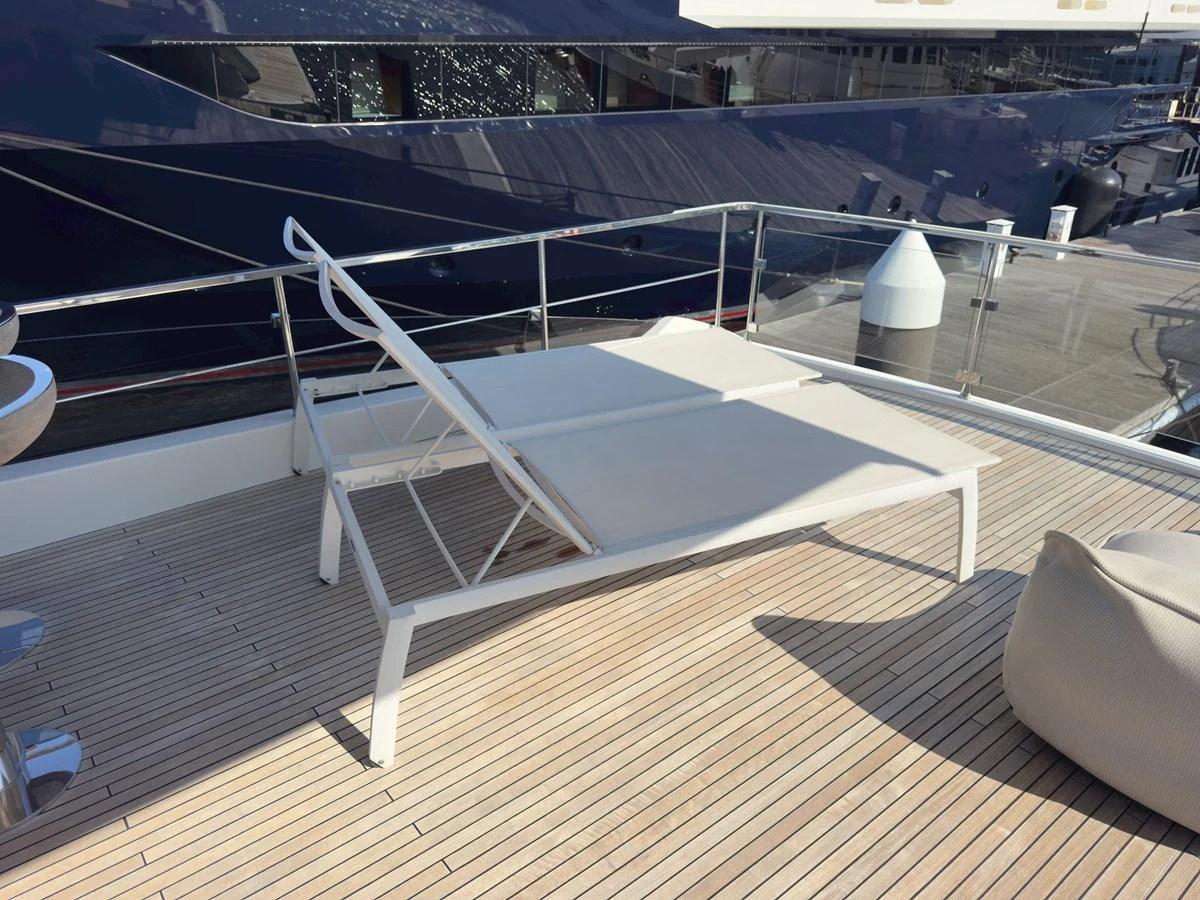 A luxurious sundeck with a comfortable sun lounger and sleek decking. aboard 2022 AZIMUT GRANDE 25M Yacht for Sale