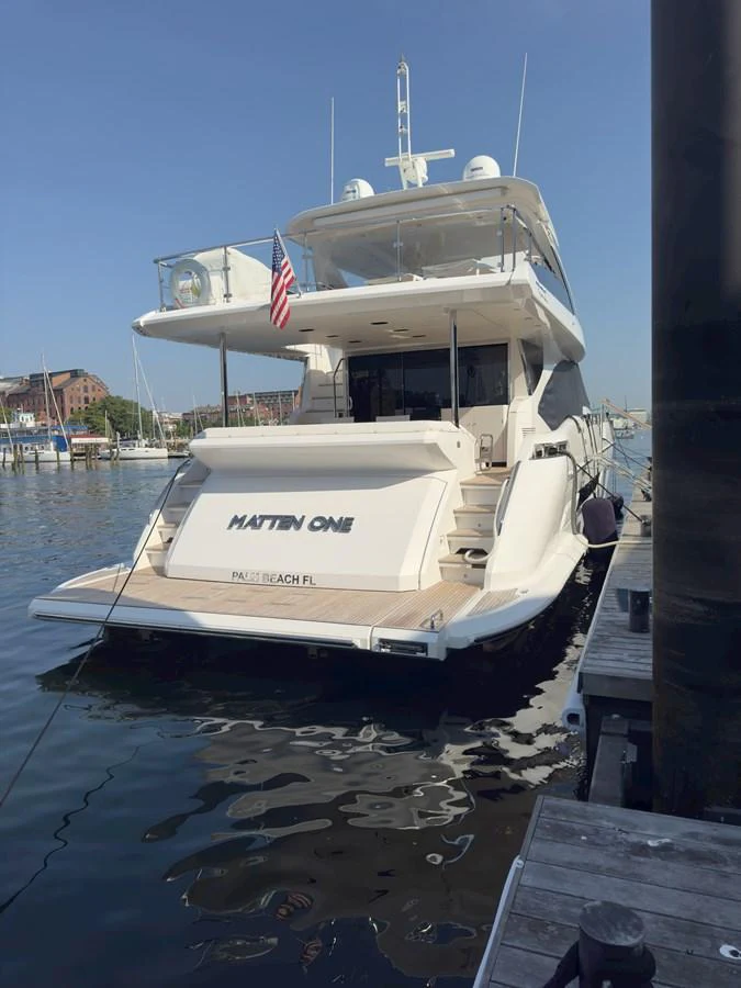 A luxurious yacht is docked at the marina, showcasing its sleek design and spacious aft deck. aboard 2022 AZIMUT GRANDE 25M Yacht for Sale