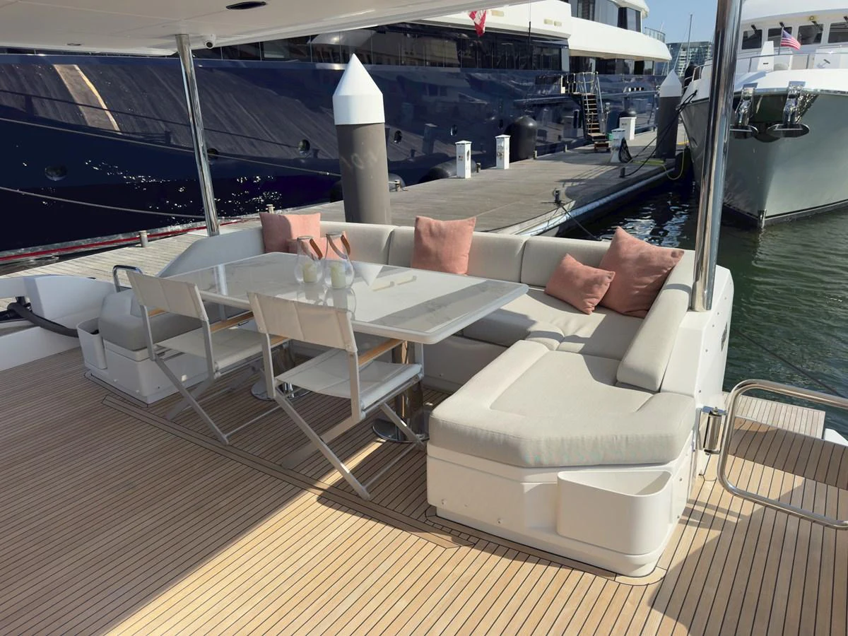 The aft deck features a comfortable seating area with a dining table, perfect for alfresco meals. aboard 2022 AZIMUT GRANDE 25M Yacht for Sale