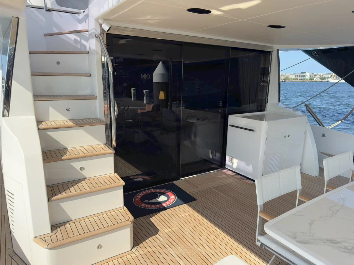 The aft deck features a stylish seating area with easy access to the interior and upper levels. aboard 2022 AZIMUT GRANDE 25M Yacht for Sale