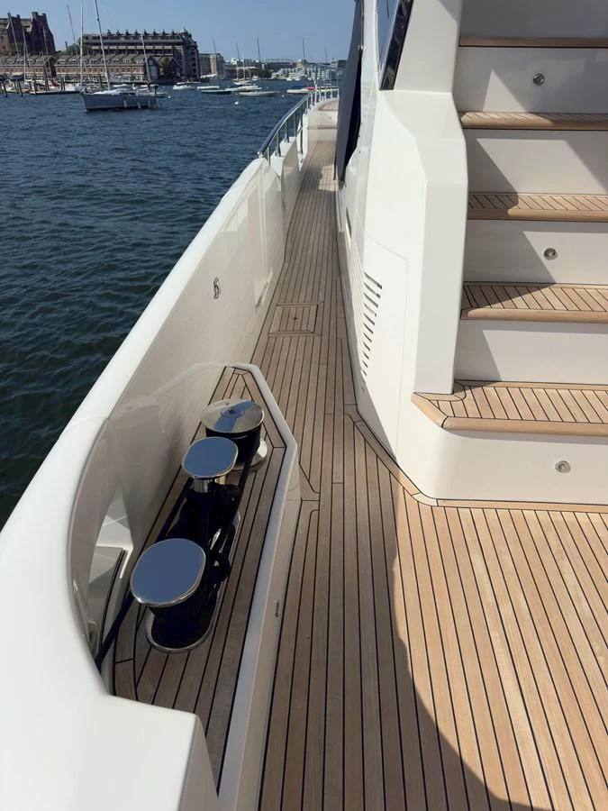 The side deck features sleek teak flooring and polished stainless steel elements, leading up to a staircase. aboard 2022 AZIMUT GRANDE 25M Yacht for Sale