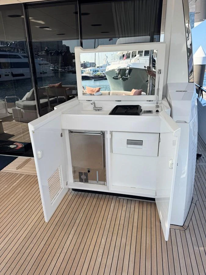 This image showcases a sleek outdoor galley area on the yacht, complete with a sink and storage compartments. aboard 2022 AZIMUT GRANDE 25M Yacht for Sale