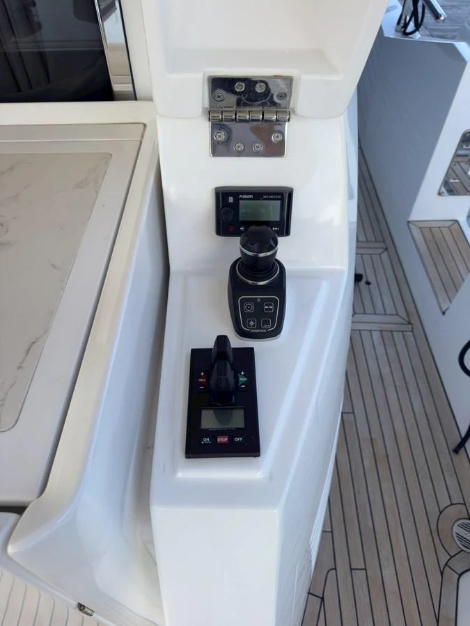 A close-up view of the yacht's helm controls, showcasing modern navigation and control equipment. aboard 2022 AZIMUT GRANDE 25M Yacht for Sale