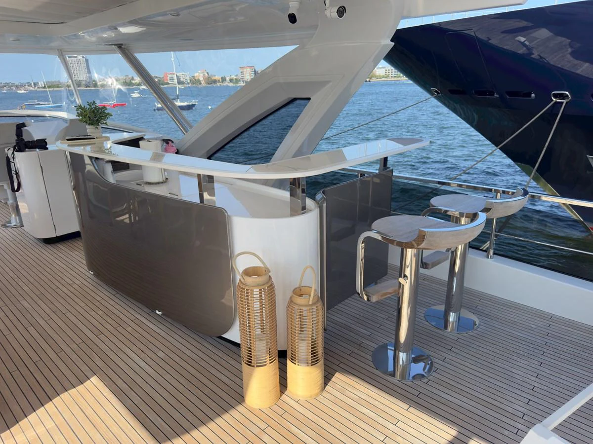 The aft deck features a stylish bar area with modern seating and elegant lanterns, perfect for entertaining. aboard 2022 AZIMUT GRANDE 25M Yacht for Sale