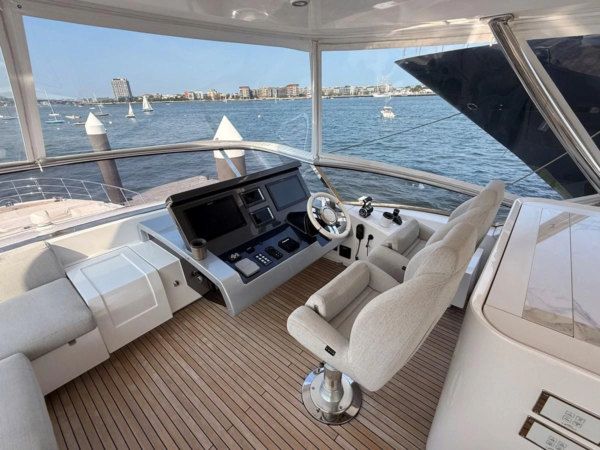 The helm station offers a commanding view with state-of-the-art navigation equipment and comfortable seating. aboard 2022 AZIMUT GRANDE 25M Yacht for Sale