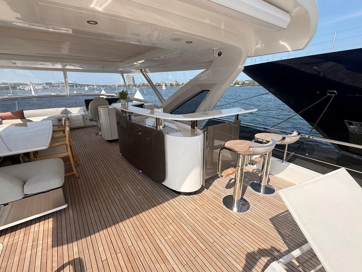 The aft deck offers a spacious and stylish area for relaxation and entertainment with a view of the water. aboard 2022 AZIMUT GRANDE 25M Yacht for Sale