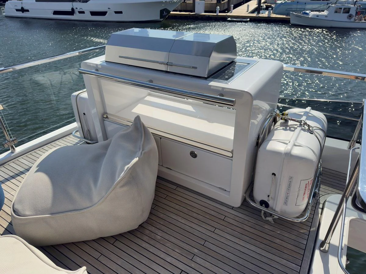 The sundeck features a sleek grill station and comfortable seating for relaxation. aboard 2022 AZIMUT GRANDE 25M Yacht for Sale