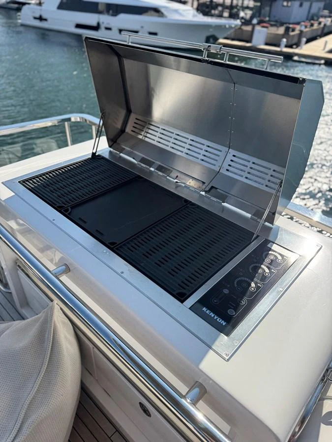 A sleek, modern grill is ready for gourmet outdoor cooking on the yacht. aboard 2022 AZIMUT GRANDE 25M Yacht for Sale