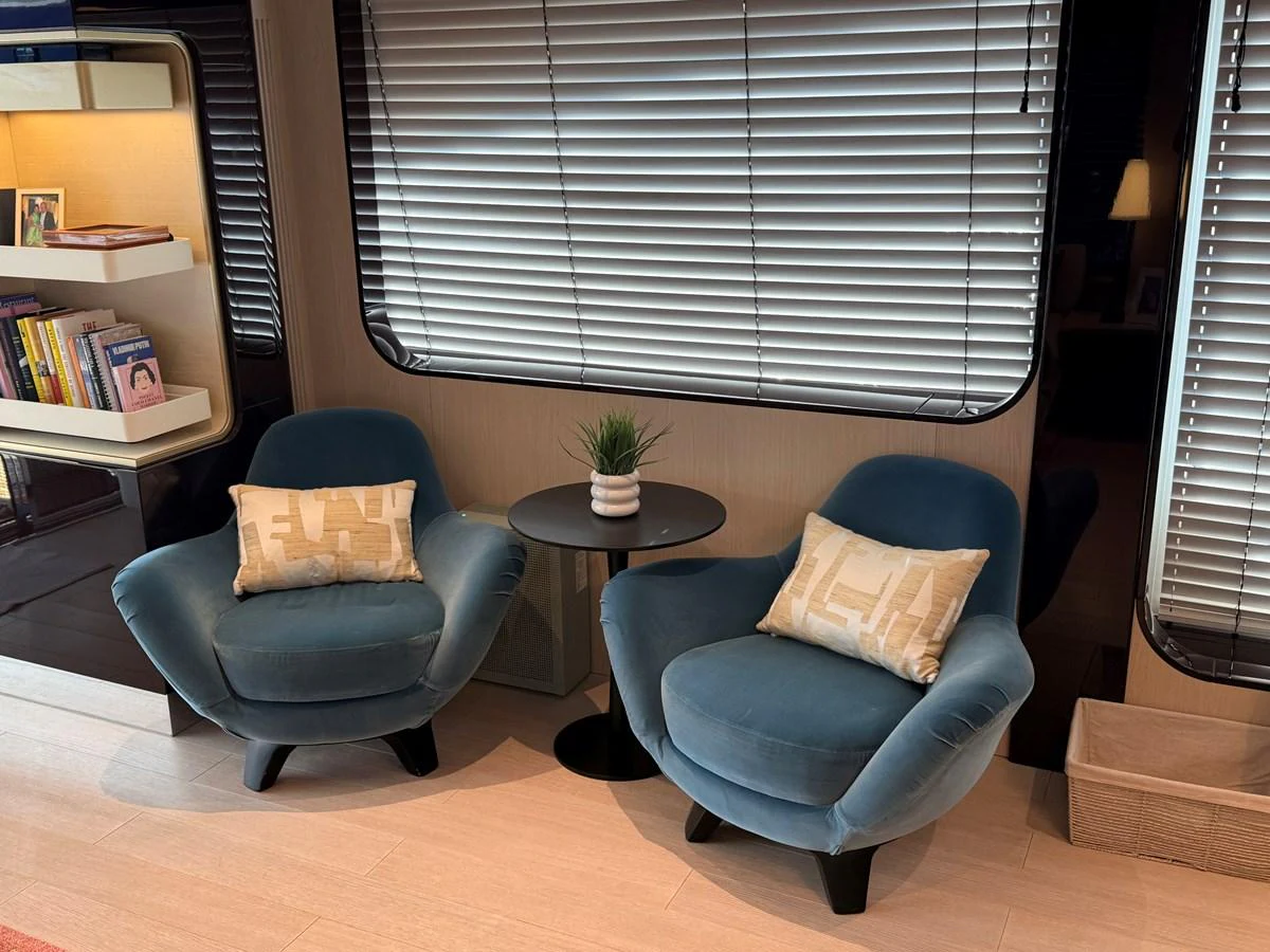 A cozy seating area with two plush armchairs and a small table, perfect for relaxation. aboard 2022 AZIMUT GRANDE 25M Yacht for Sale
