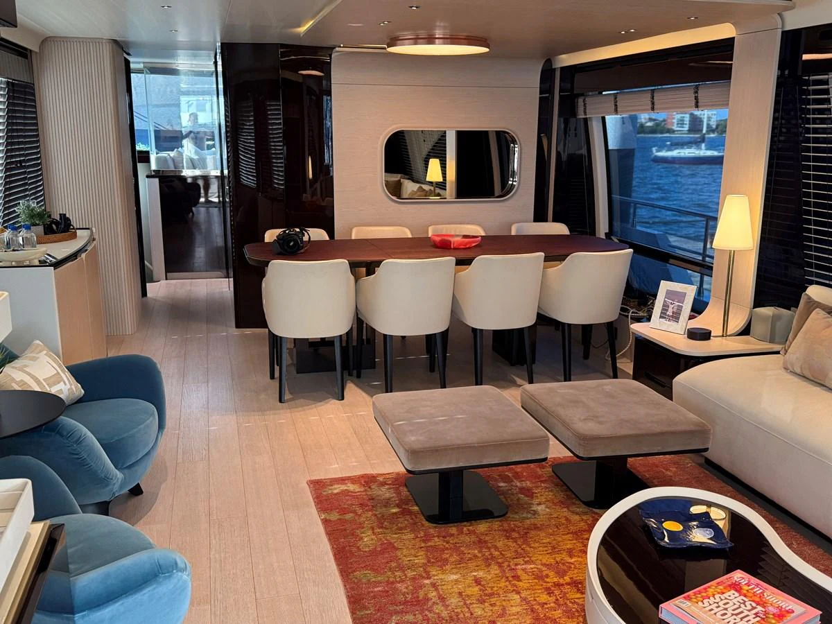 The yacht's salon features a spacious seating area with a dining table, plush chairs, and elegant decor. aboard 2022 AZIMUT GRANDE 25M Yacht for Sale