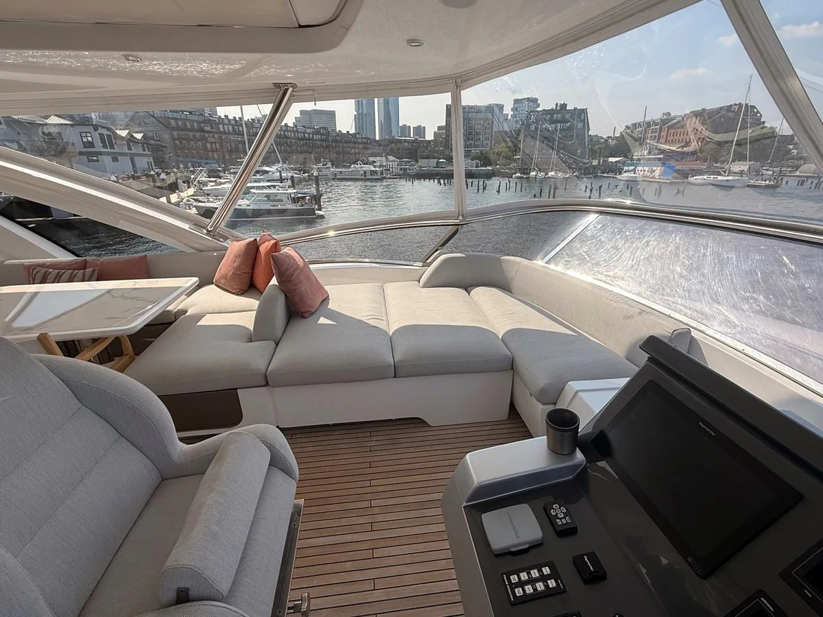 The flybridge offers a spacious seating area with a panoramic view of the marina. aboard 2022 AZIMUT GRANDE 25M Yacht for Sale