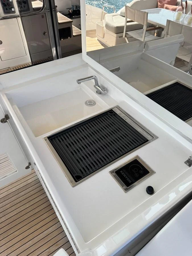 This image showcases a sleek and modern galley area with a built-in grill and sink. aboard 2022 AZIMUT GRANDE 25M Yacht for Sale