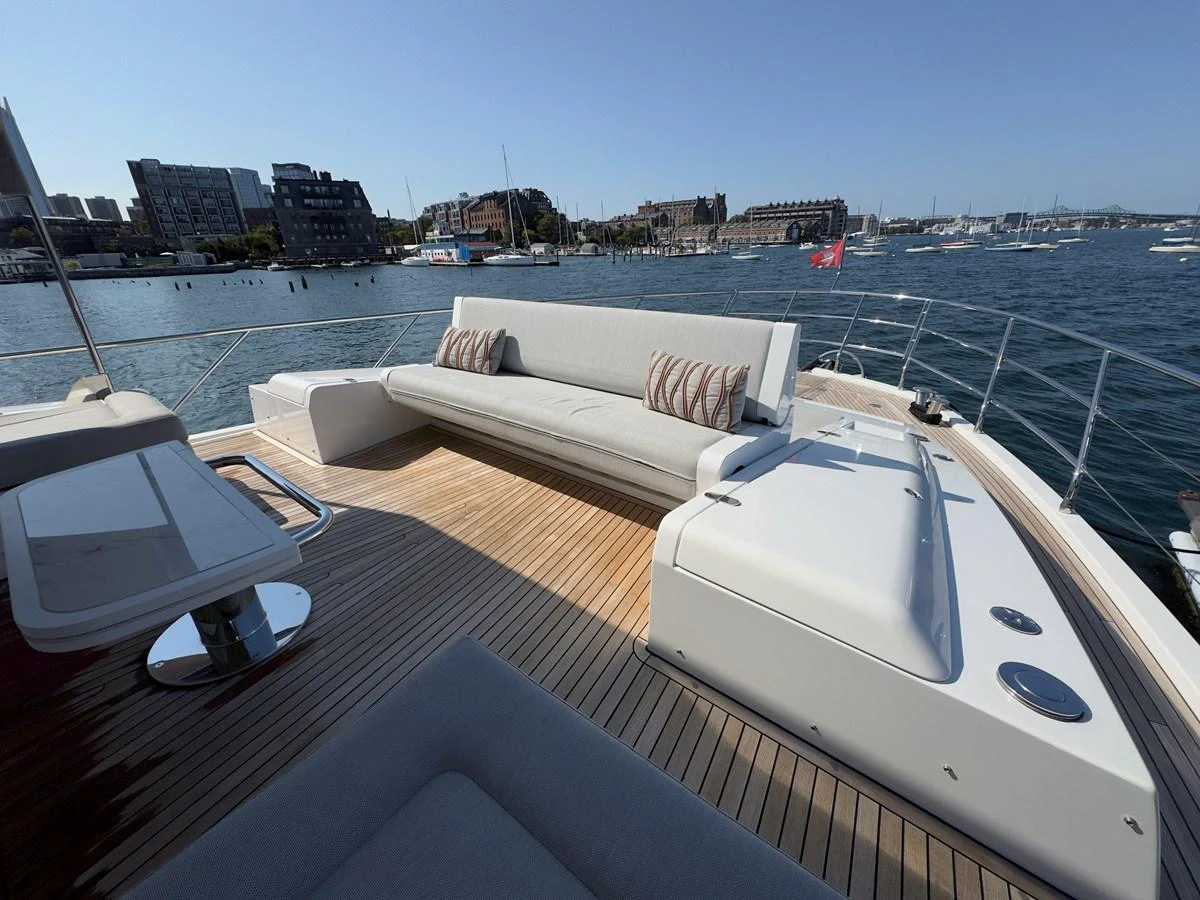 The aft deck features a spacious seating area with a stunning view of the surrounding marina. aboard 2022 AZIMUT GRANDE 25M Yacht for Sale