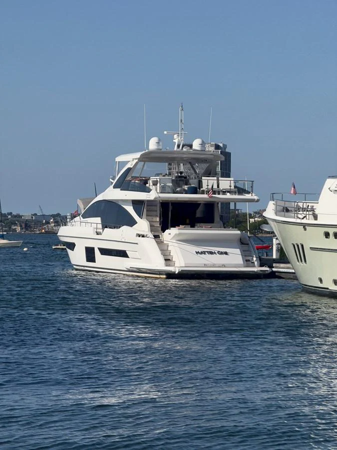 A sleek yacht is docked in a serene marina, showcasing its modern design and spacious decks. aboard 2022 AZIMUT GRANDE 25M Yacht for Sale