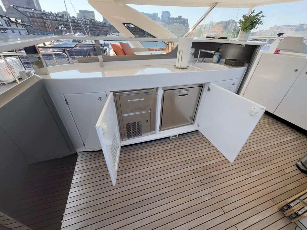 The yacht features a well-equipped outdoor galley with modern appliances and ample storage. aboard 2022 AZIMUT GRANDE 25M Yacht for Sale