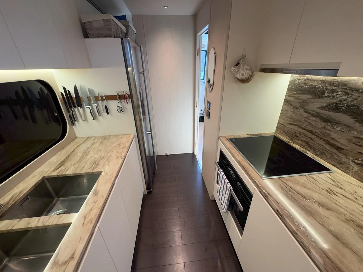 The galley features modern appliances and ample counter space, perfect for gourmet cooking at sea. aboard 2022 AZIMUT GRANDE 25M Yacht for Sale