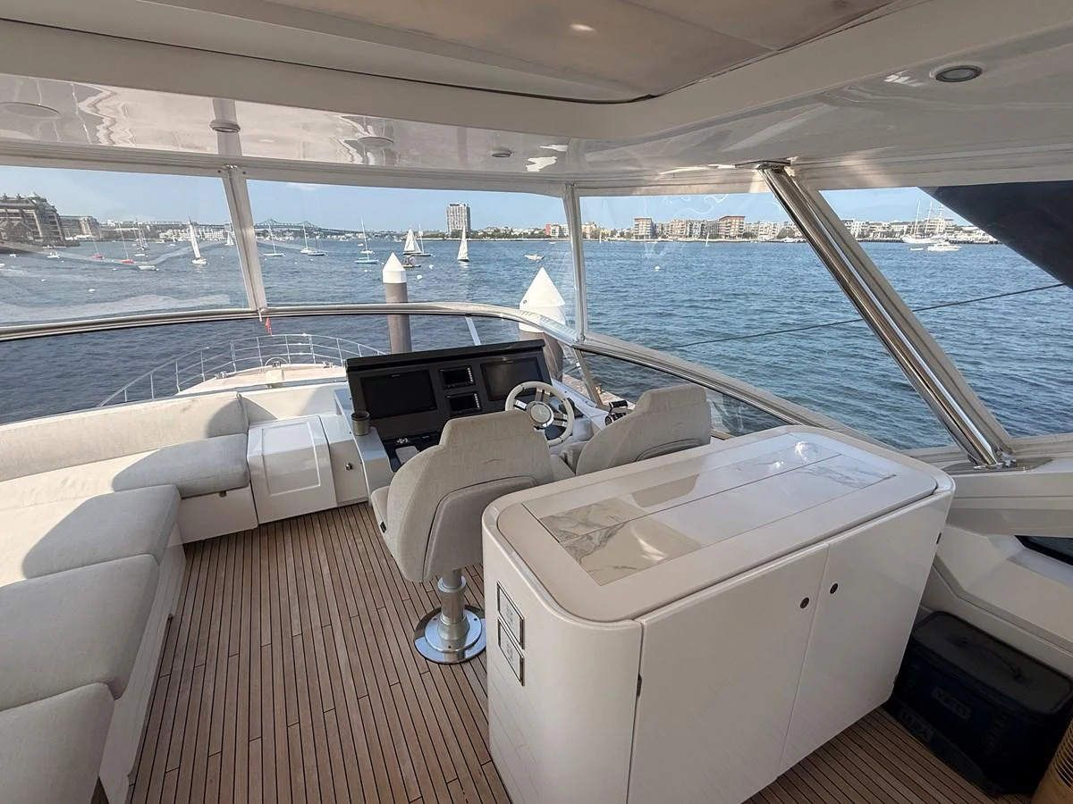 The helm station offers a panoramic view with comfortable seating and modern navigation equipment. aboard 2022 AZIMUT GRANDE 25M Yacht for Sale