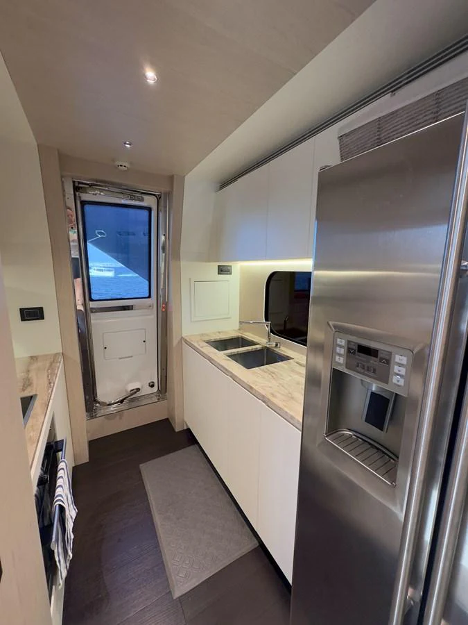 The yacht's galley features modern appliances and a sleek design, perfect for gourmet cooking at sea. aboard 2022 AZIMUT GRANDE 25M Yacht for Sale