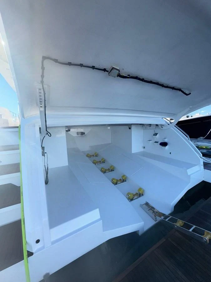 The image showcases the yacht's tender garage with an open hatch, revealing storage space for watercraft. aboard 2022 AZIMUT GRANDE 25M Yacht for Sale