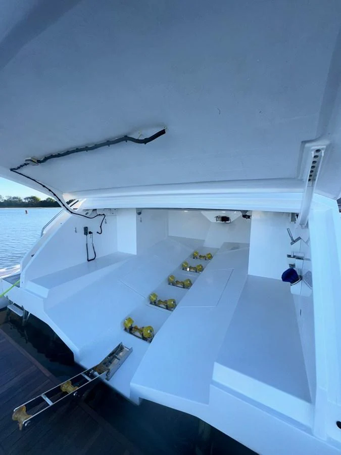 The yacht's garage is open, revealing ample storage space for equipment and water toys. aboard 2022 AZIMUT GRANDE 25M Yacht for Sale